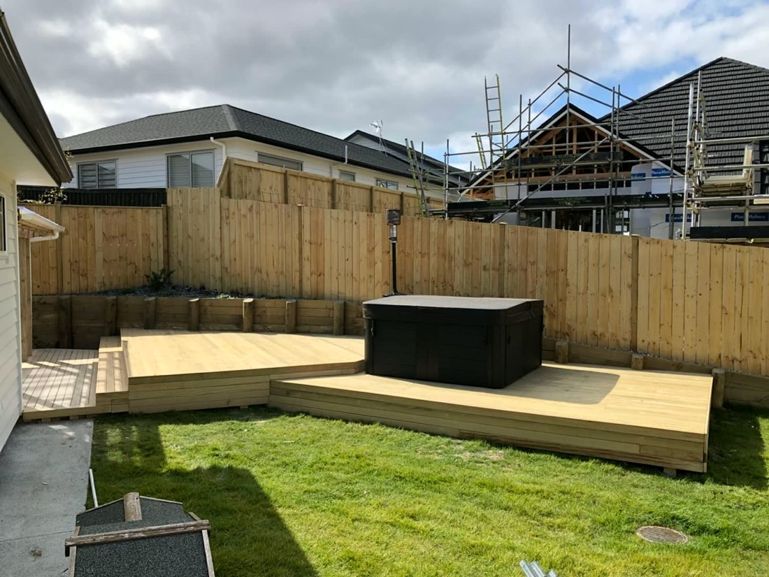Backyard timber deck with fence and spa area