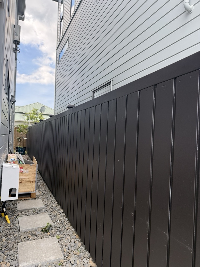 Black timber boundary fence