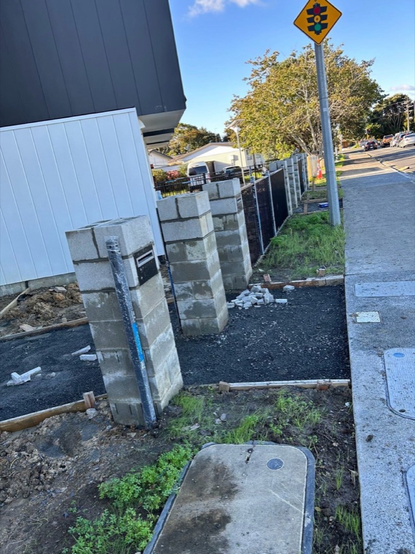 Boundary blockwork and entrance site preparation beside a footpath