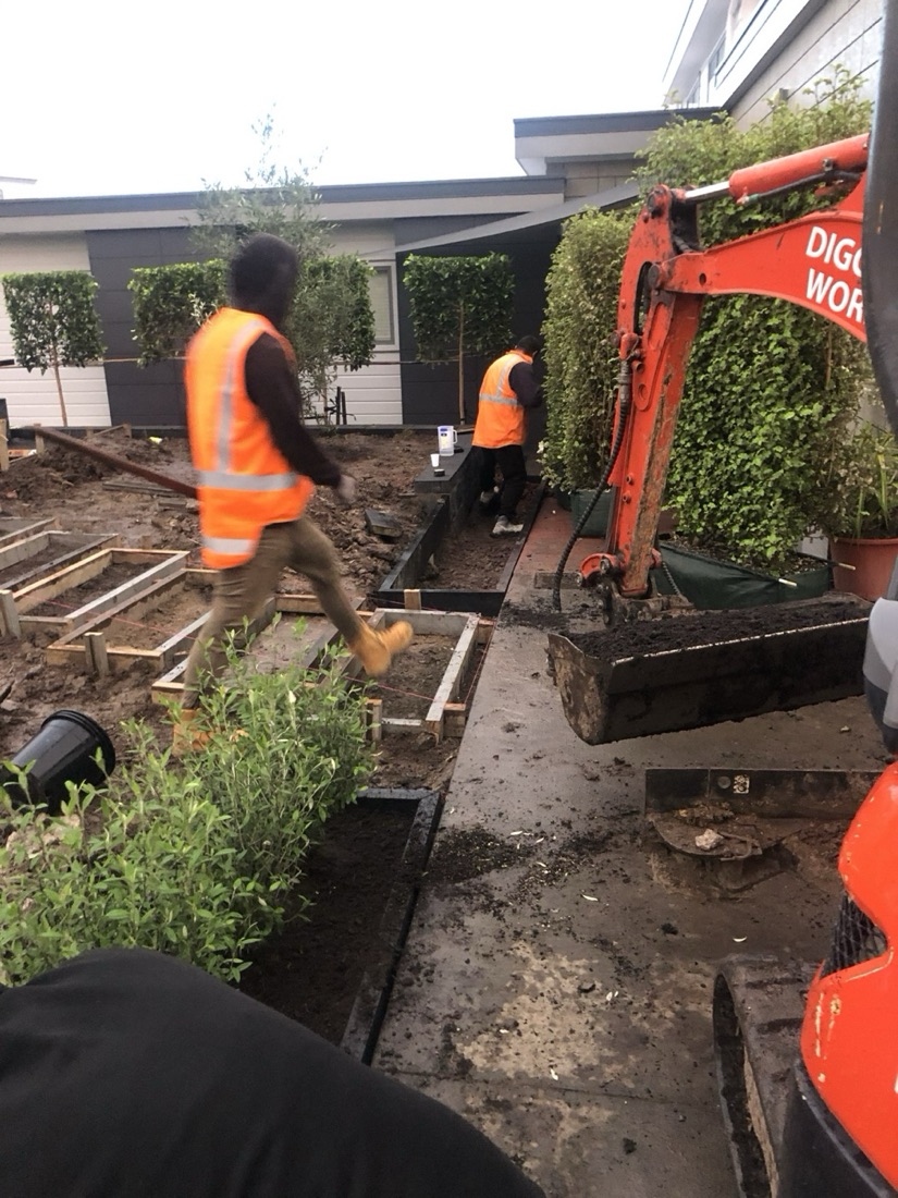 Excavator earthworks and garden construction preparation