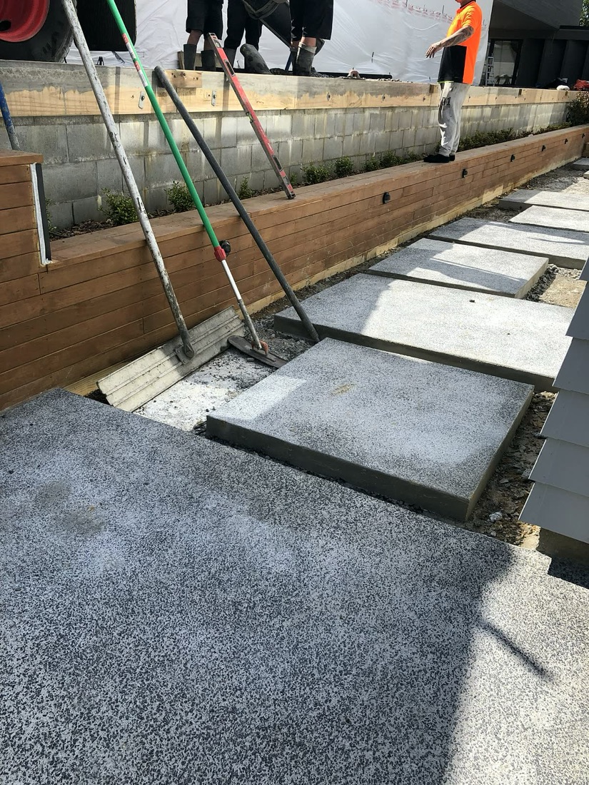 Exposed aggregate concrete access steps with retaining and planting