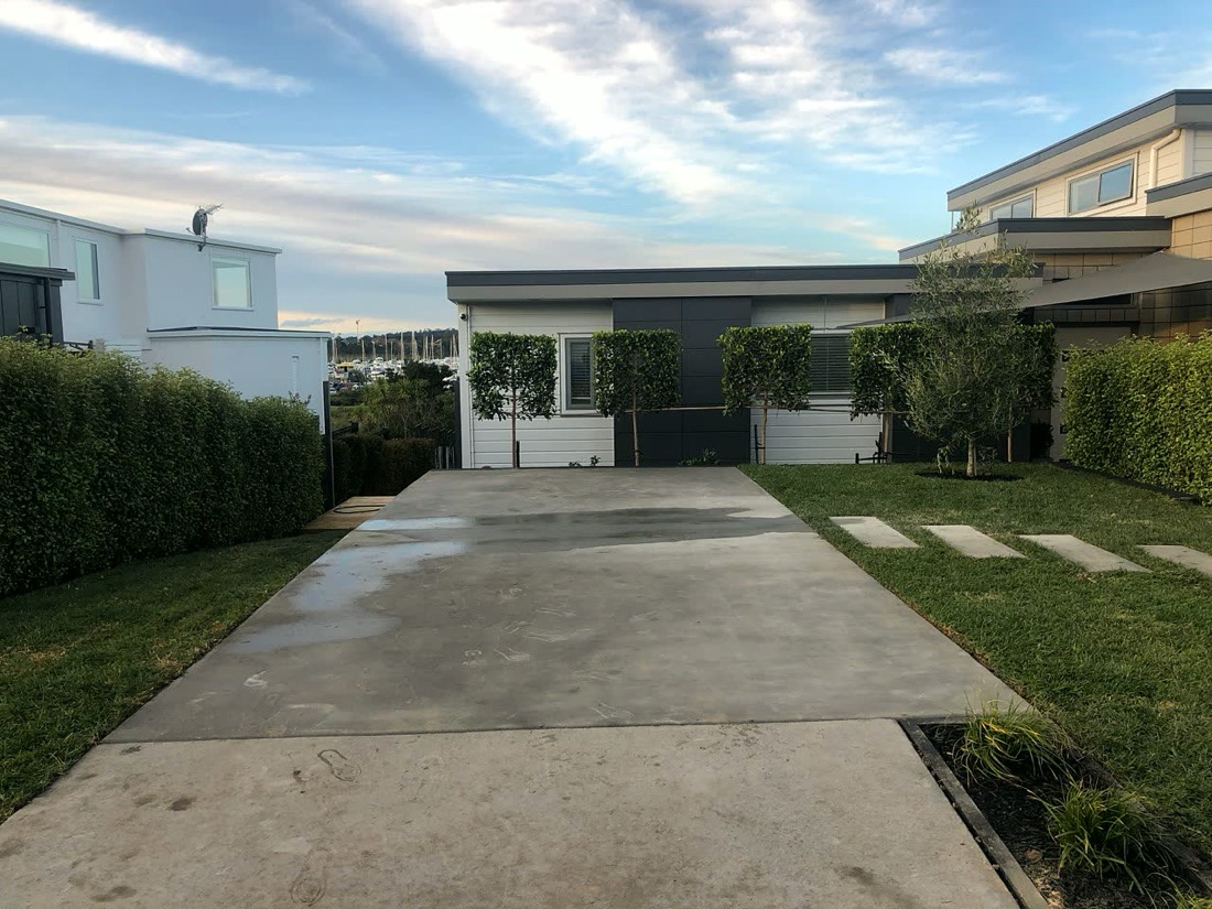 Finished concrete driveway with lawn and garden edging