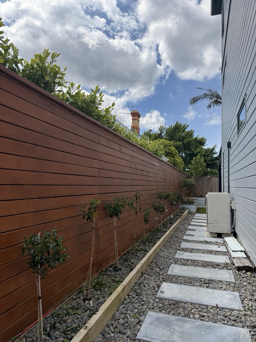 Garden path with stepping stones, planting and timber boundary screen