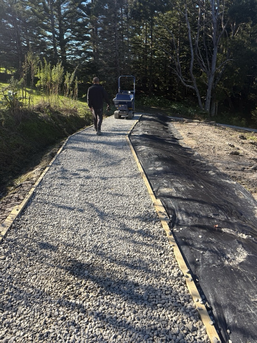 Gravel garden path construction with timber edging and access equipment
