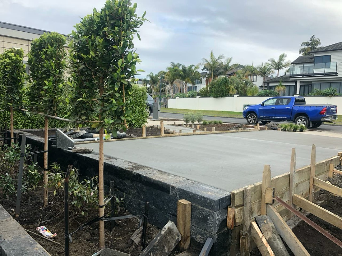 Raised concrete pad supported by block retaining and timber boxing