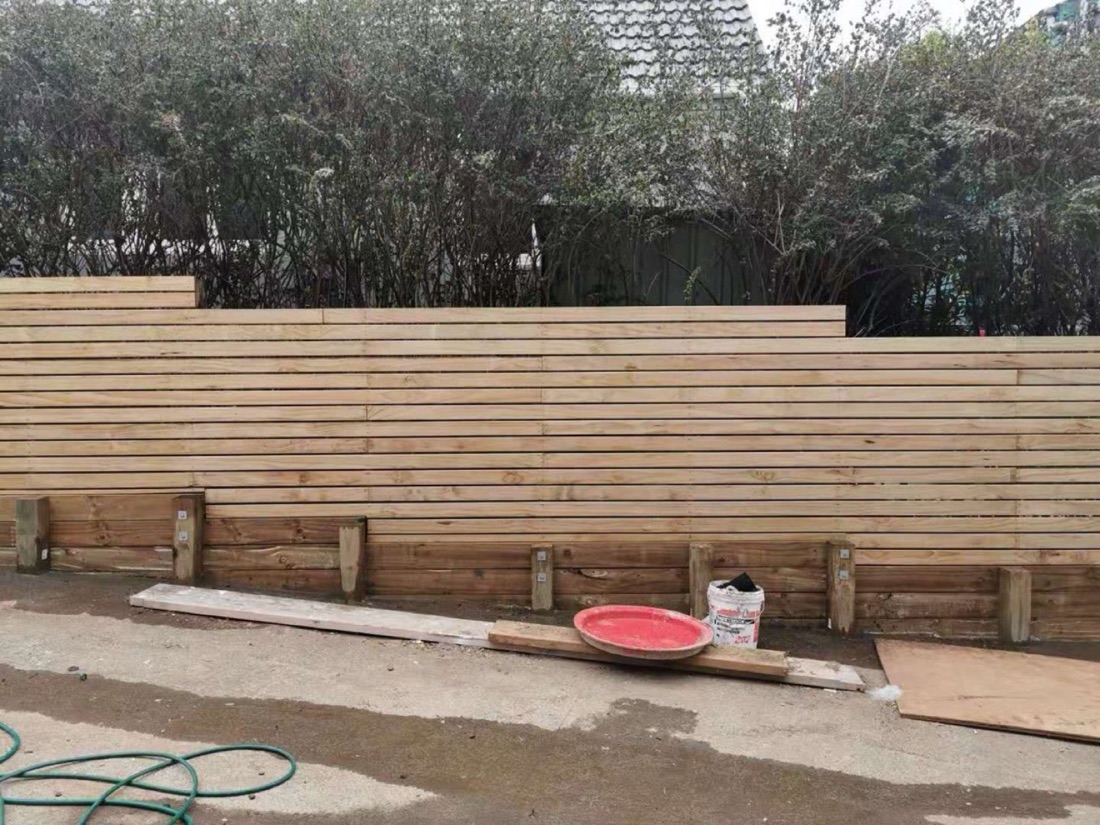 Stepped timber retaining wall in a residential outdoor area